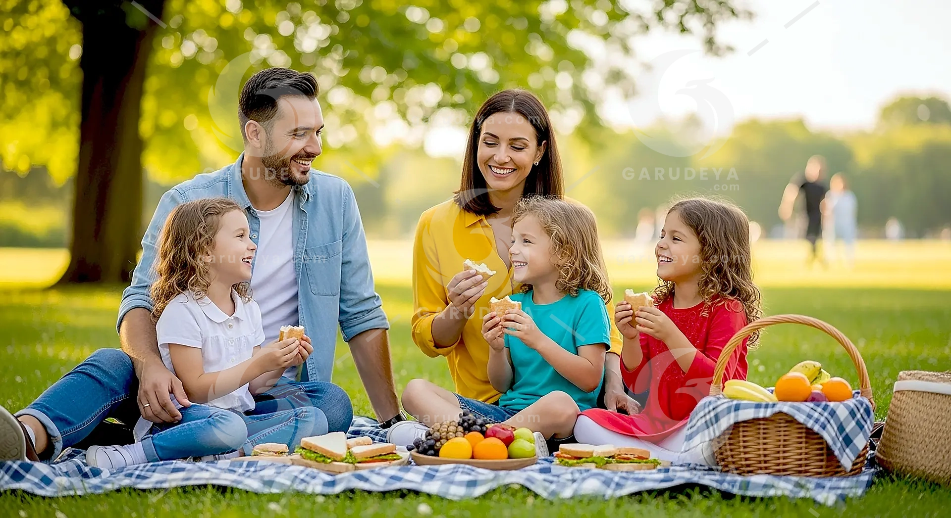 Family Lifestyle Picnic Outdoors with Parents and Children Smiling Together