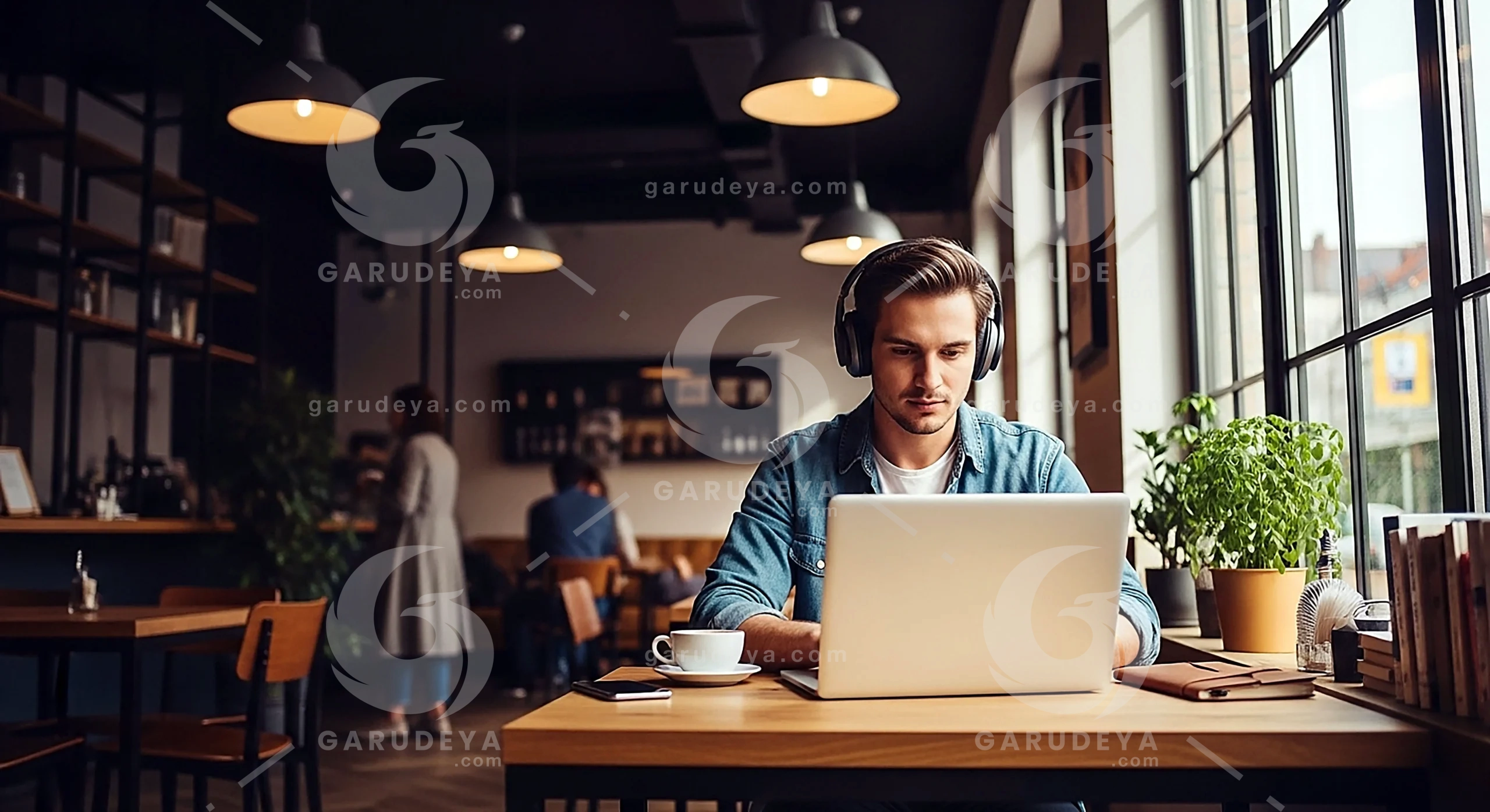 Man Working On Laptop In Café